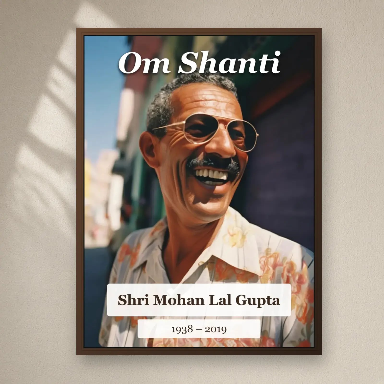 Om Shanti Memorial Frame on a plain wall